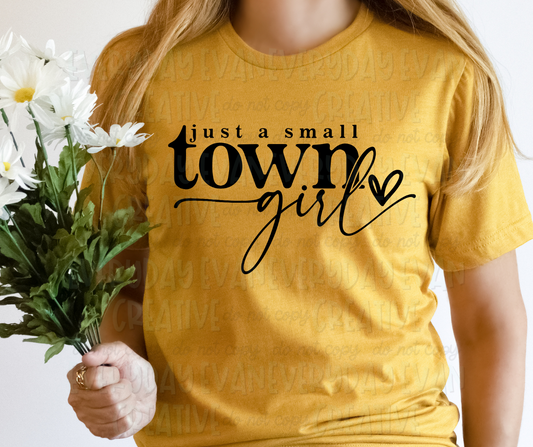 Image displays a person wearing a t-shirt holding a bouquet of flowers. The shirt's design reads, "just a small town girl" in serif and script font with a scribbled heart to the left of the text.