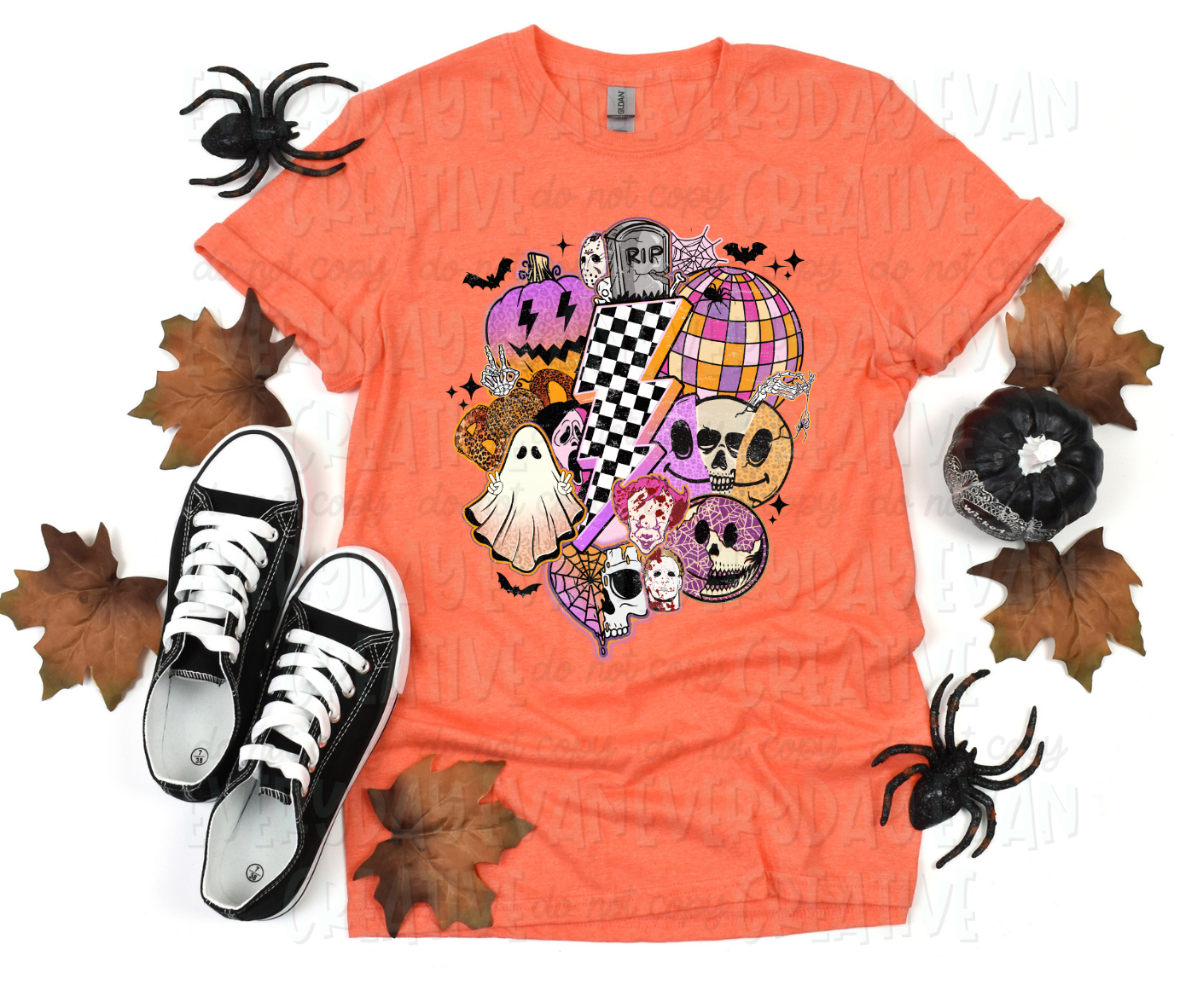 A flat lay of a t-shirt surrounded by fall-themed decorations. In the middle, a large checkered lightening bolt is surrounded by various Halloween-themed images including a sheet ghost, several skulls, smiling faces, pumpkins, bats, a gravestone, webs, and starbursts. All images appear in a collage.