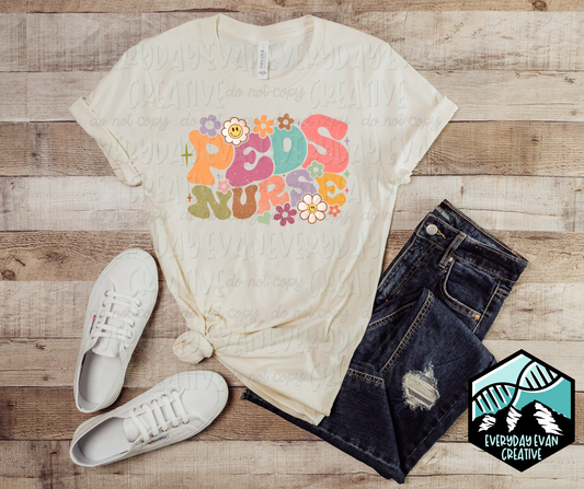 Image of a t-shirt with a retro Peds Nurse design with floral motifs
